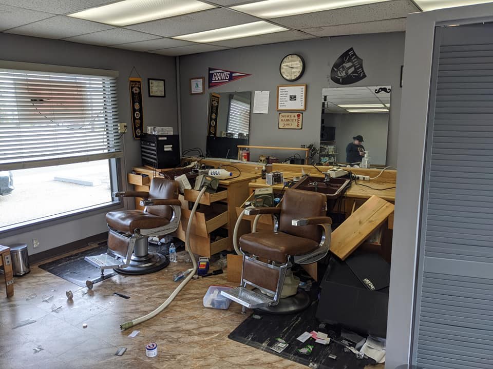 The brown barber chairs and mirrored stations inside Iron Barber